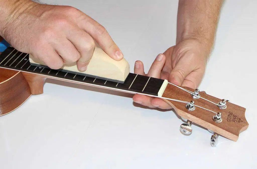 sanding down the ukulele frets to counteract ukulele buzzing